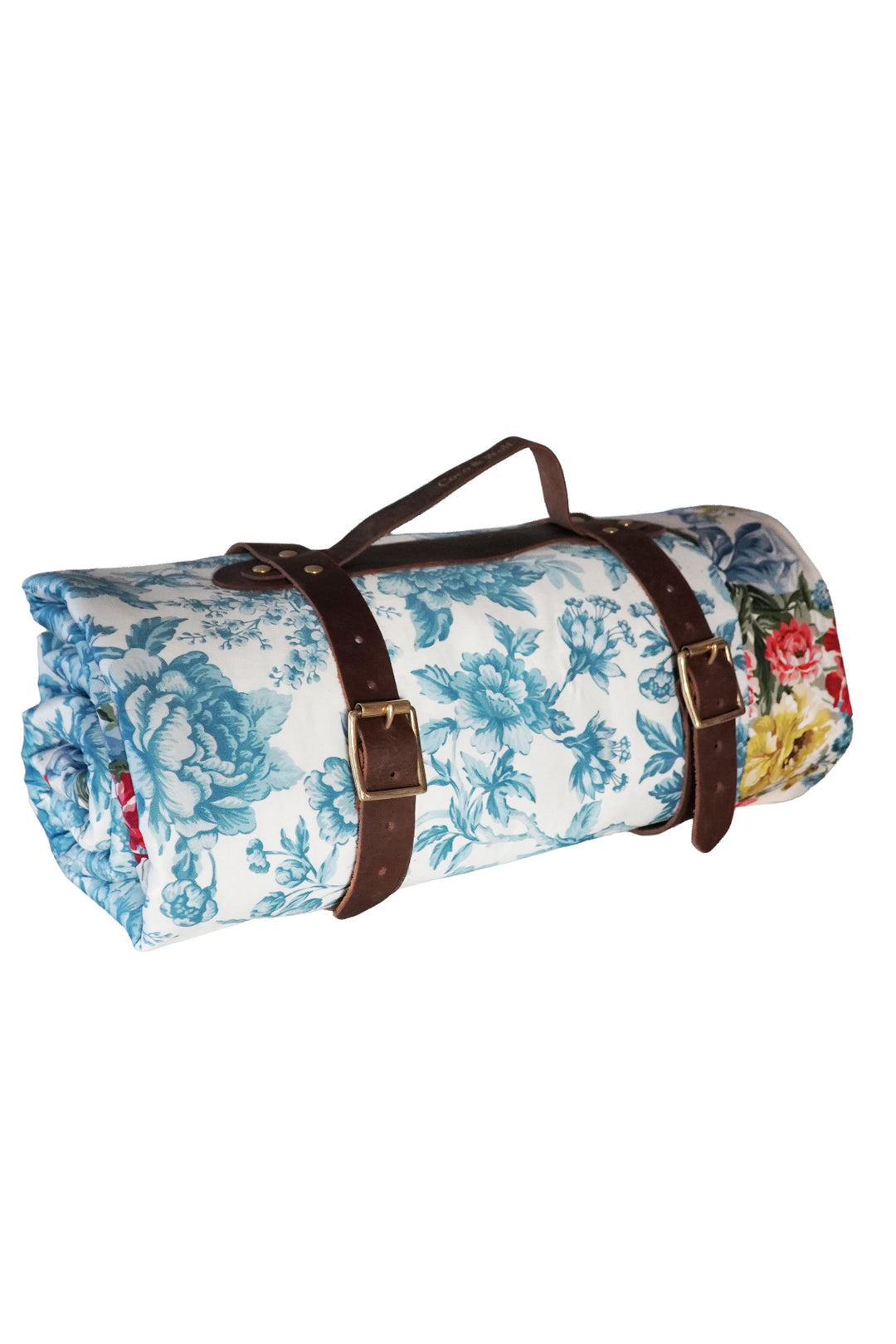 Floral-patterned roll-up rug with brown straps on a white background