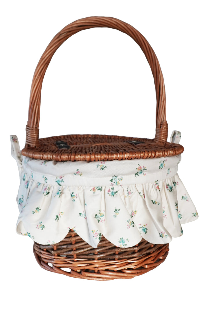 Wicker basket with floral fabric liner on a white background
