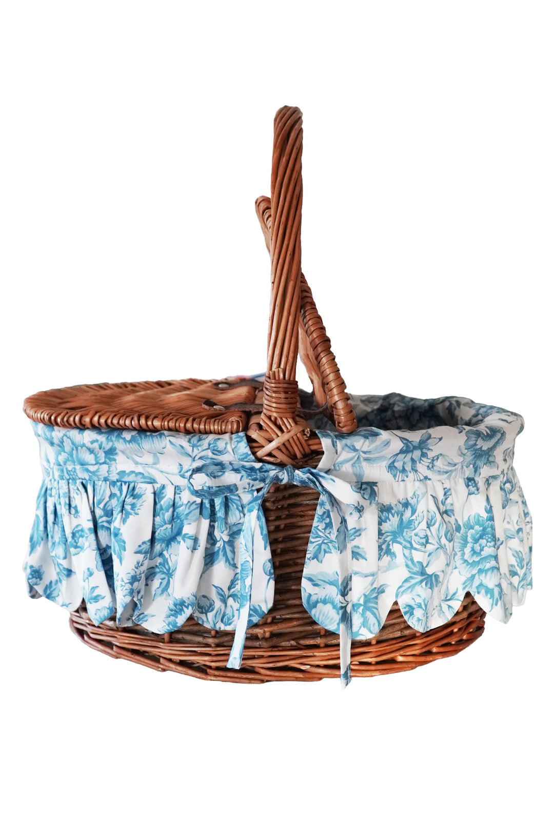 Wicker basket with floral fabric liner on a white background
