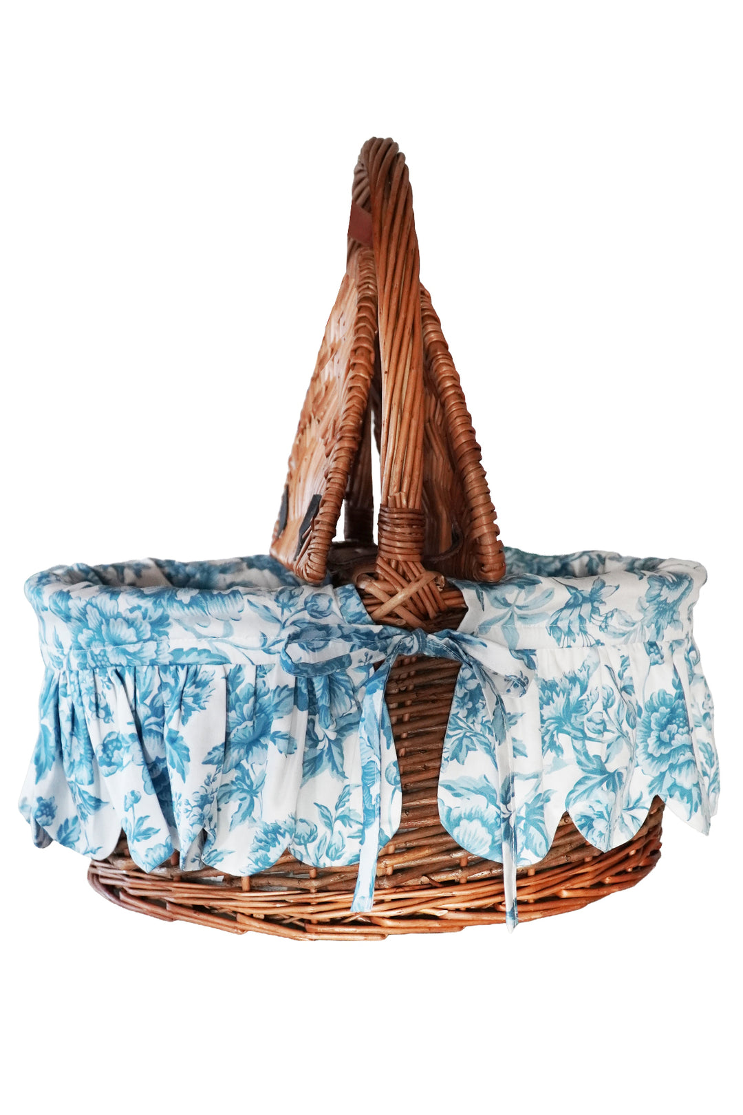 Wicker baby Moses basket with floral canopy on a white background