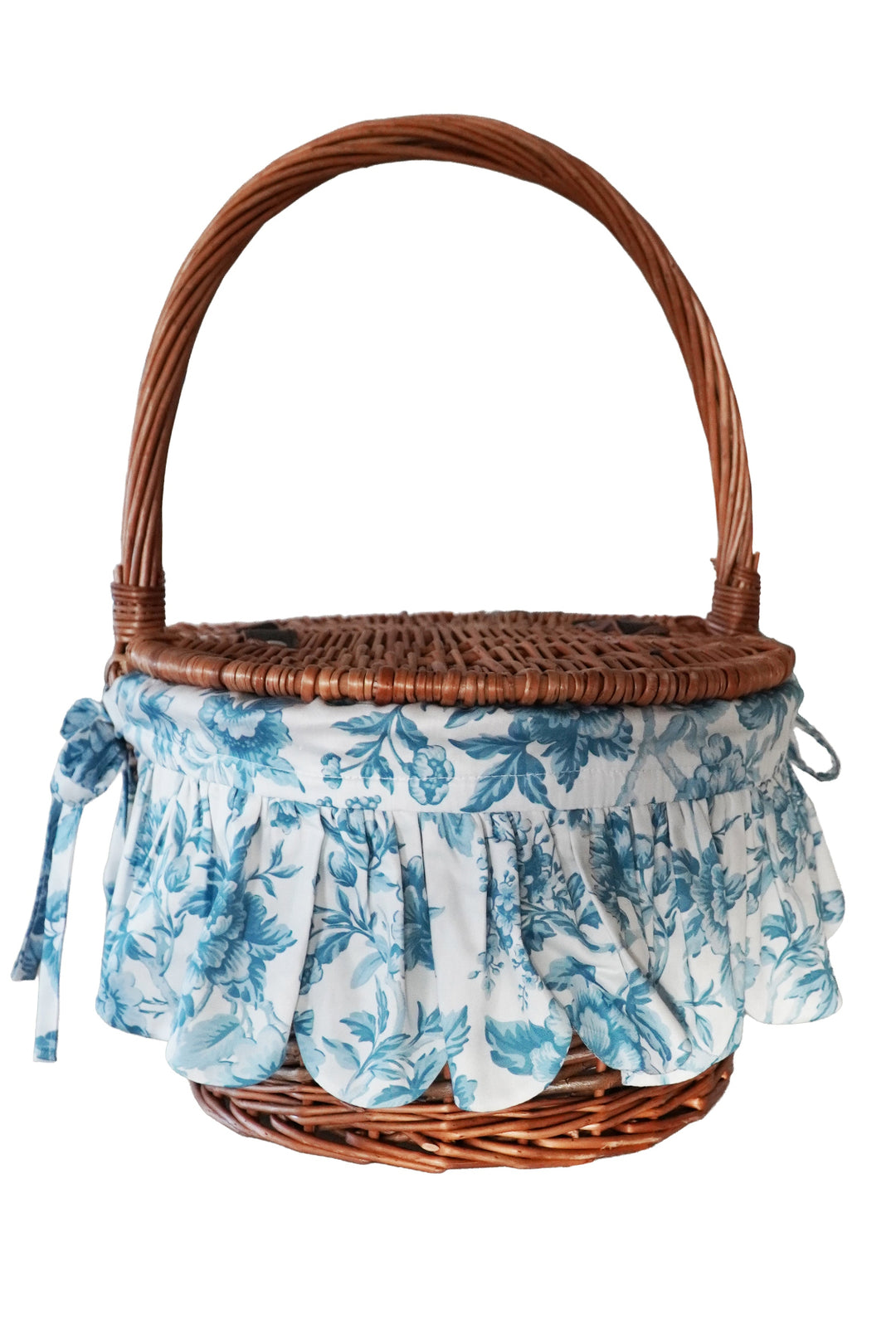 Wicker basket with floral fabric liner on a white background