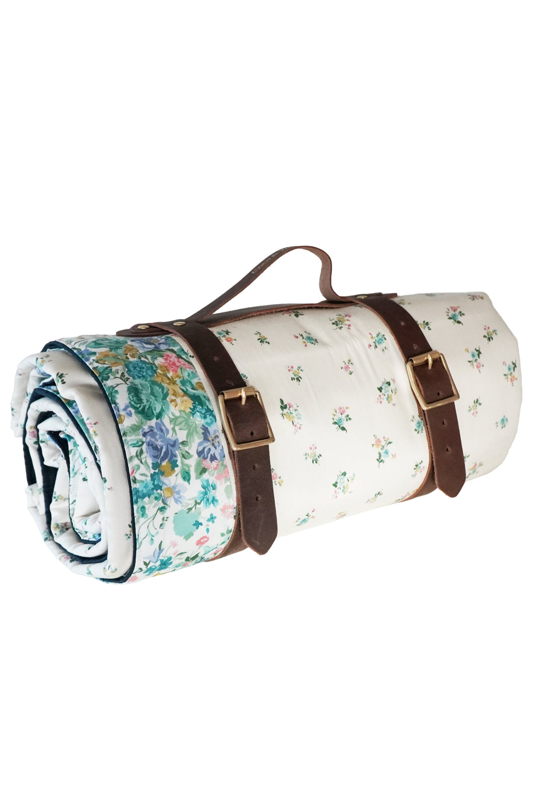 Roll-up floral picnic blanket with brown straps on a white background