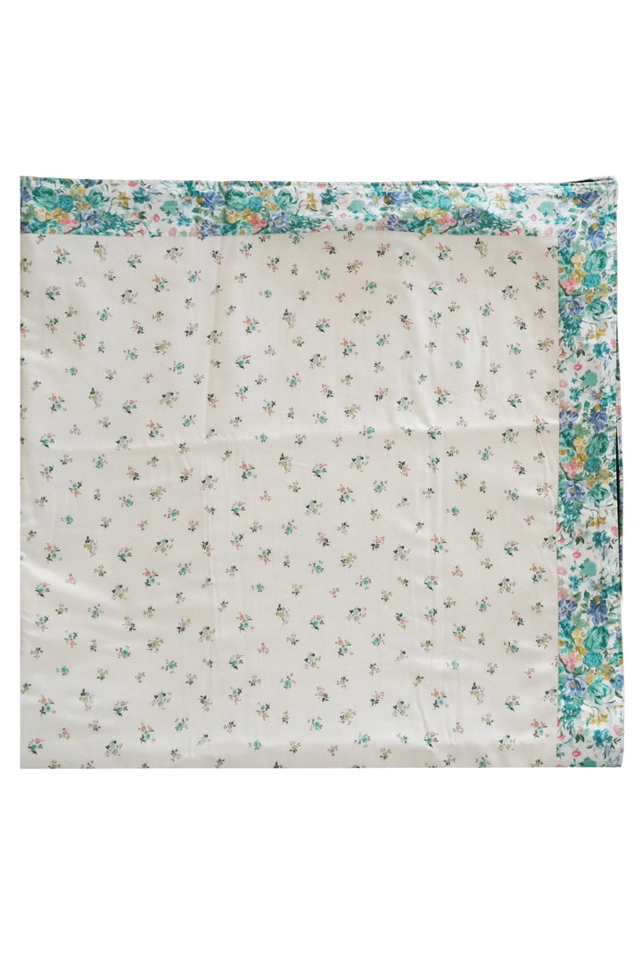 Floral-patterned fabric with a colorful border on a white background