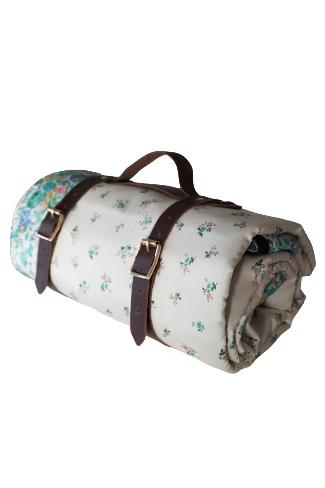Roll-up picnic blanket with floral pattern and brown straps on a white background