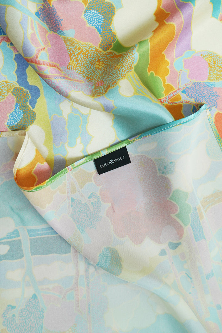 Close-up of silk scarf showing Liberty fabric print and fine rolled edges